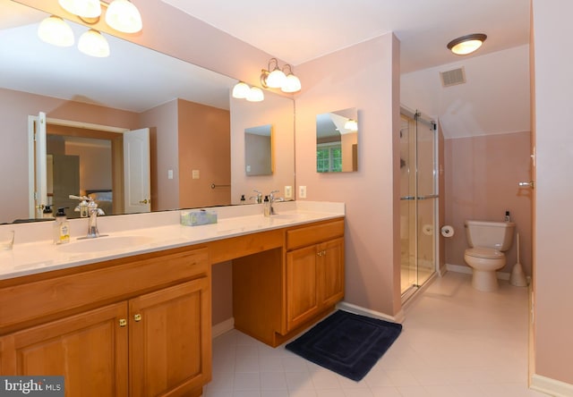 bathroom featuring toilet, a stall shower, double vanity, and baseboards