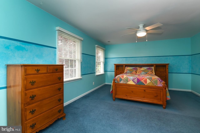 carpeted bedroom featuring baseboards and a ceiling fan