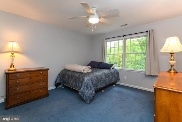 bedroom featuring baseboards, dark colored carpet, and a ceiling fan