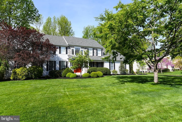 colonial home with a front lawn