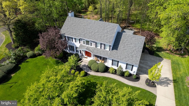 view of subject property with a heavily wooded area