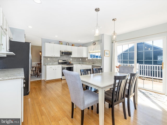dining area featuring light wood-style floors and recessed lighting