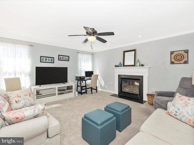 carpeted living room with ceiling fan, crown molding, a fireplace with flush hearth, baseboards, and recessed lighting