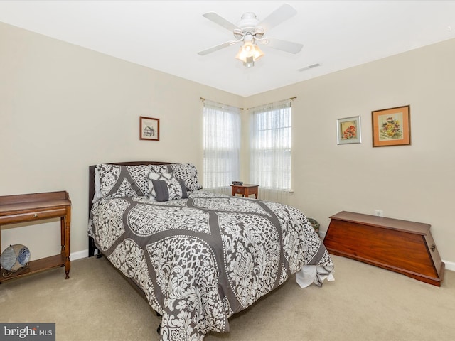 bedroom with baseboards, ceiling fan, carpet flooring, and visible vents