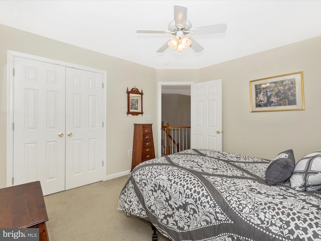 carpeted bedroom with a ceiling fan and a closet
