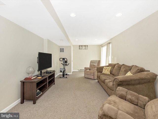 living area with baseboards, light colored carpet, and visible vents