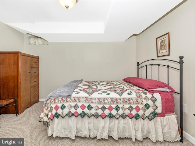 bedroom featuring baseboards and light colored carpet