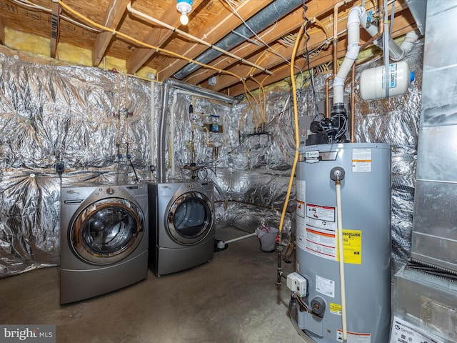 laundry area with water heater, separate washer and dryer, and laundry area