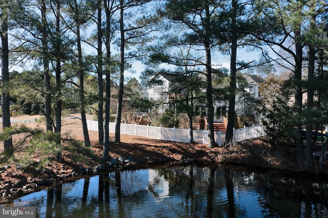 property view of water with fence private yard
