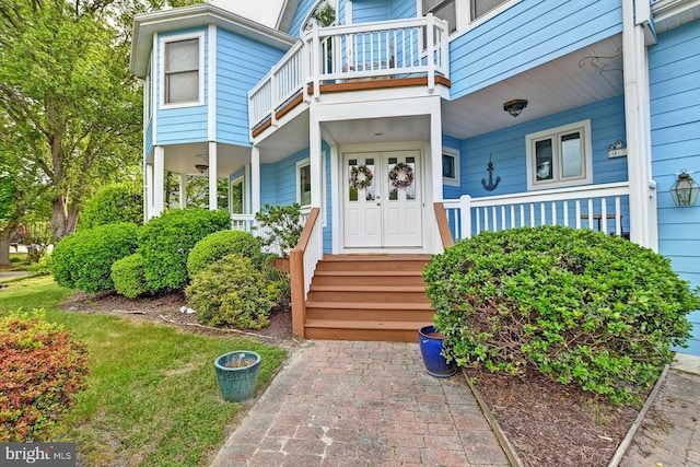 entrance to property with a porch and a balcony