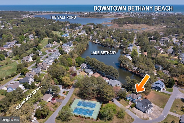 drone / aerial view featuring a water view and a residential view