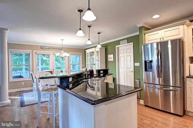 kitchen featuring light wood-style floors, stainless steel fridge, and plenty of natural light