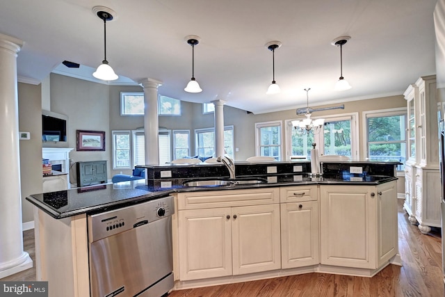 kitchen with decorative columns, dishwasher, a sink, ornamental molding, and light wood-style flooring