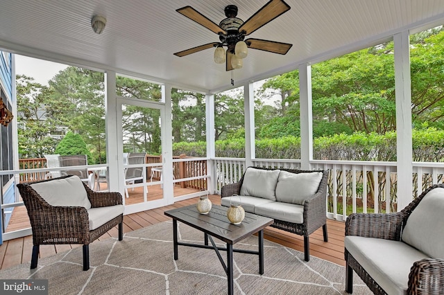 sunroom with a ceiling fan and an outdoor hangout area