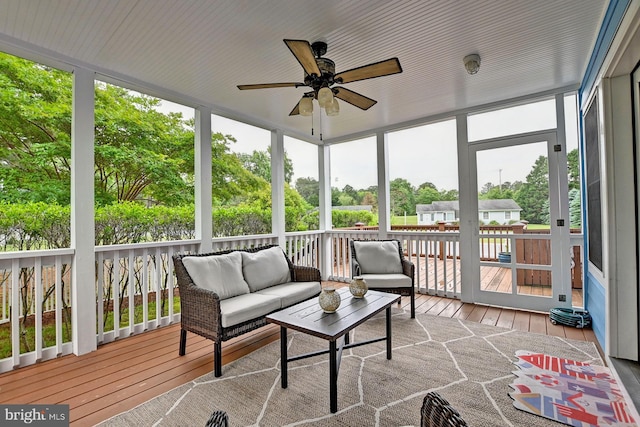 sunroom featuring an outdoor living space and ceiling fan