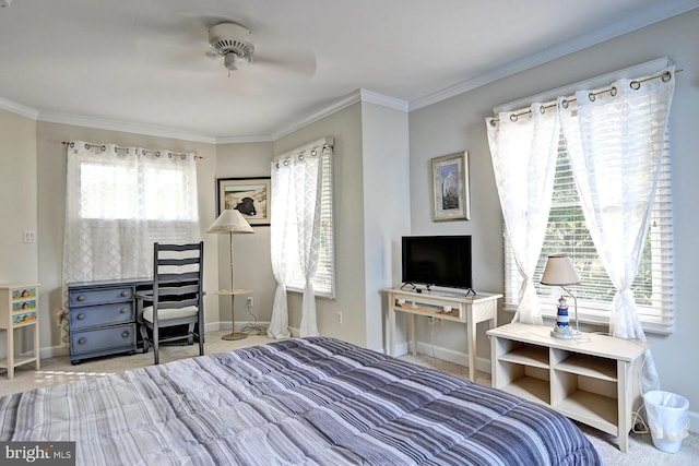 carpeted bedroom with baseboards, a ceiling fan, and crown molding