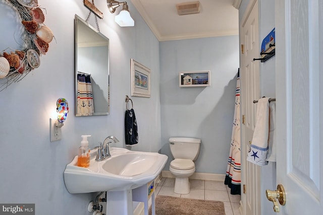 full bath with crown molding, baseboards, tile patterned floors, and toilet