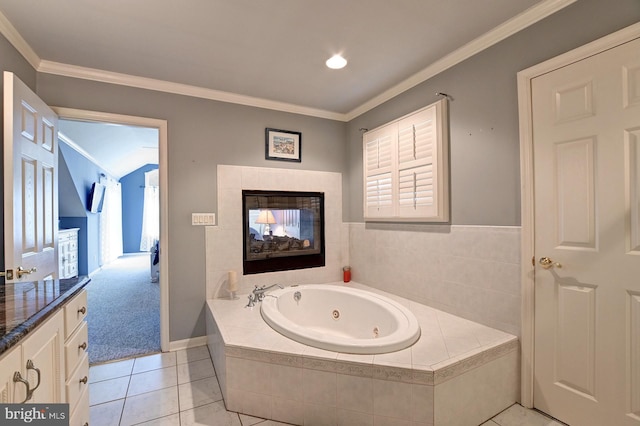 bathroom featuring crown molding, a whirlpool tub, tile patterned flooring, and a tile fireplace