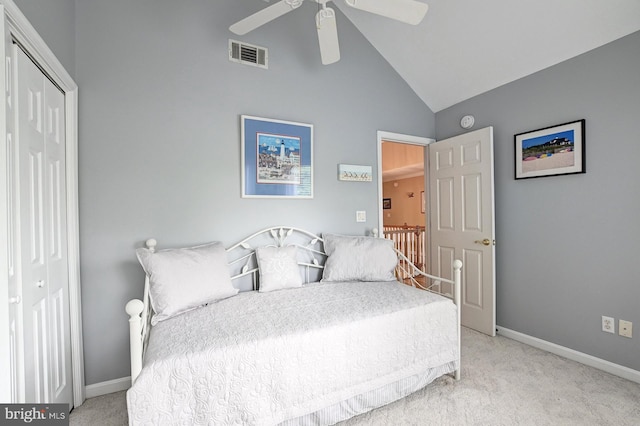 carpeted bedroom featuring visible vents, baseboards, high vaulted ceiling, and a closet