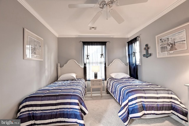 bedroom with ornamental molding, carpet, ceiling fan, and visible vents