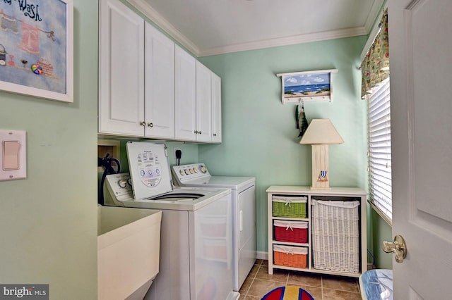 laundry room featuring washing machine and clothes dryer, light tile patterned floors, ornamental molding, and a healthy amount of sunlight