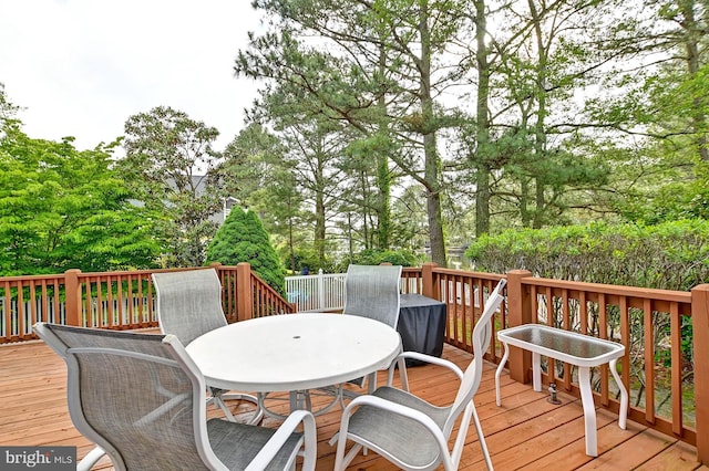 wooden terrace featuring outdoor dining space