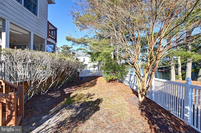 view of yard with a water view and a fenced backyard