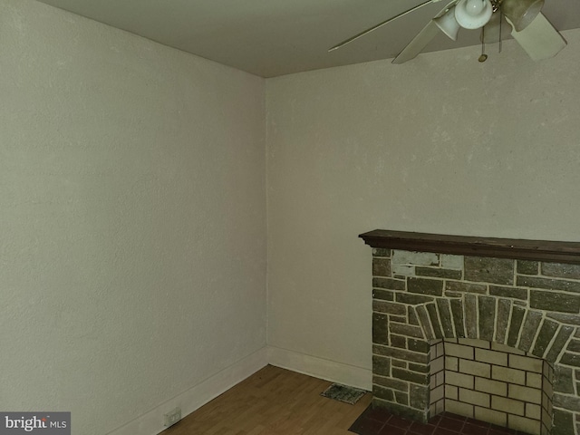 423 Furrow St, Baltimore, MD 21223 - room details with ceiling fan, a fireplace, and wood finished floors