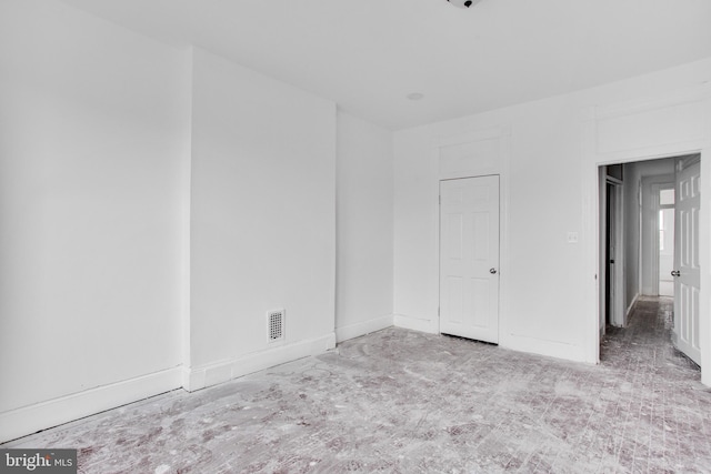 unfurnished bedroom with baseboards and visible vents