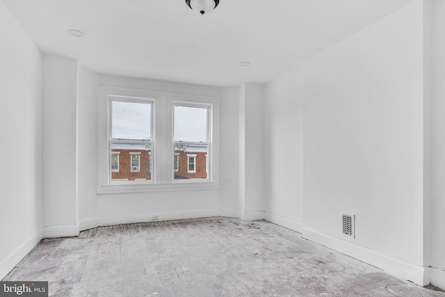 spare room featuring baseboards and visible vents