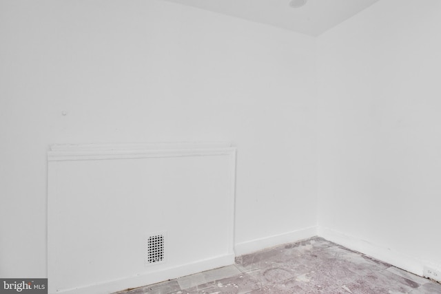 spare room featuring baseboards