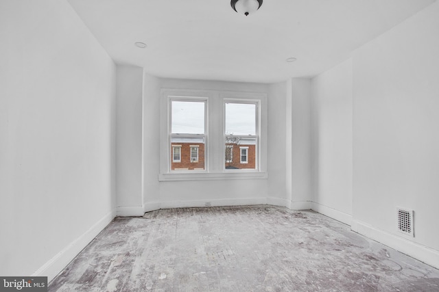empty room with baseboards and visible vents