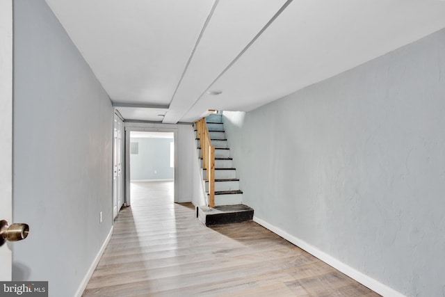 interior space featuring stairway, baseboards, and wood finished floors