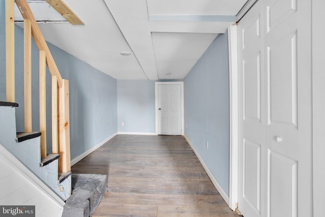 interior space featuring baseboards, stairs, and wood finished floors