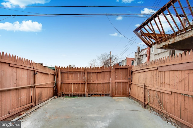 view of patio featuring fence and a gate
