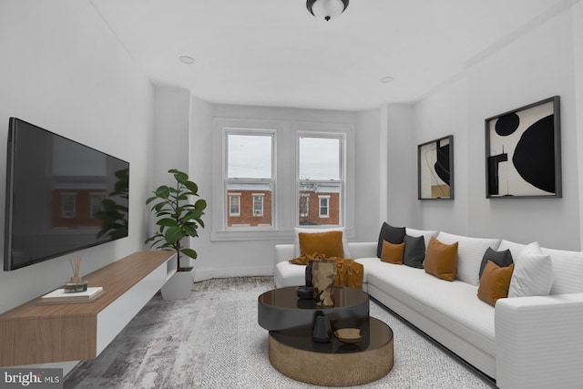 living area with baseboards and wood finished floors