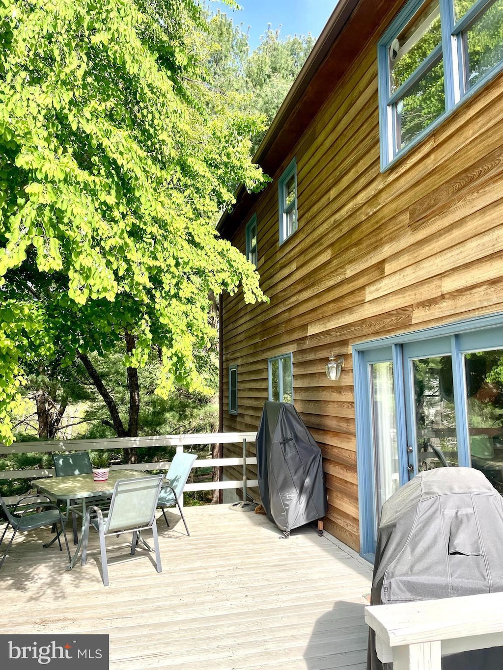 wooden deck featuring outdoor dining area and grilling area
