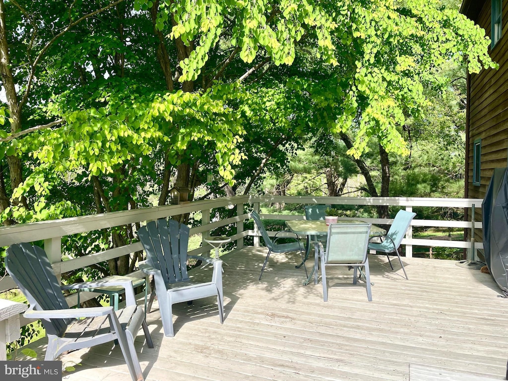 wooden deck featuring outdoor dining area