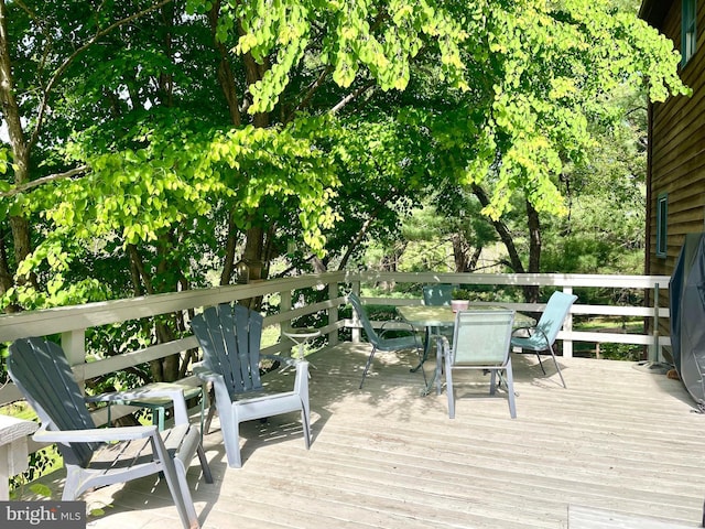 wooden deck featuring outdoor dining area