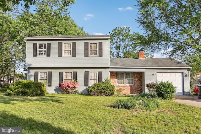 colonial-style house featuring a garage, a front lawn, a chimney, brick siding, and concrete driveway