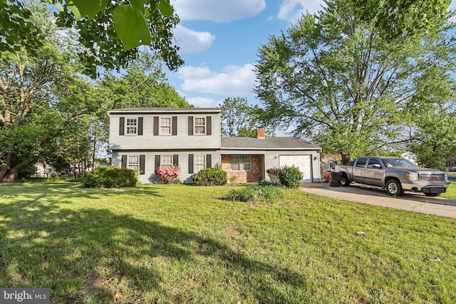 colonial house featuring driveway, a chimney, a front lawn, and a garage