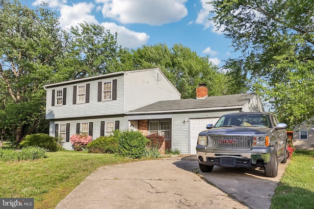 colonial inspired home featuring an attached garage, a chimney, driveway, and a front lawn