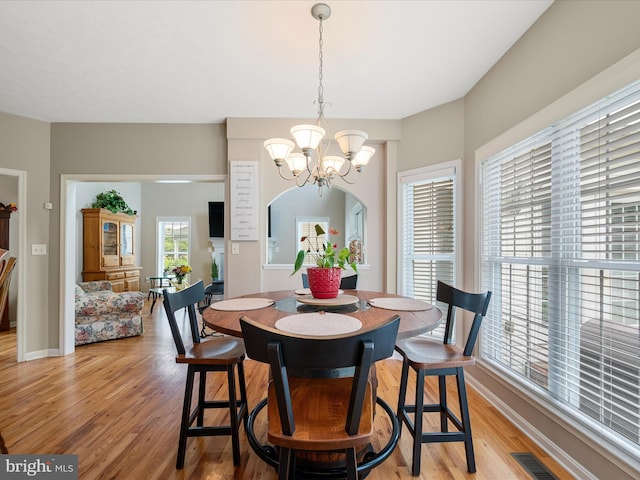 114 New Market Dr, Stephens City, VA 22655 - dining area with a chandelier, light wood-type flooring, and baseboards