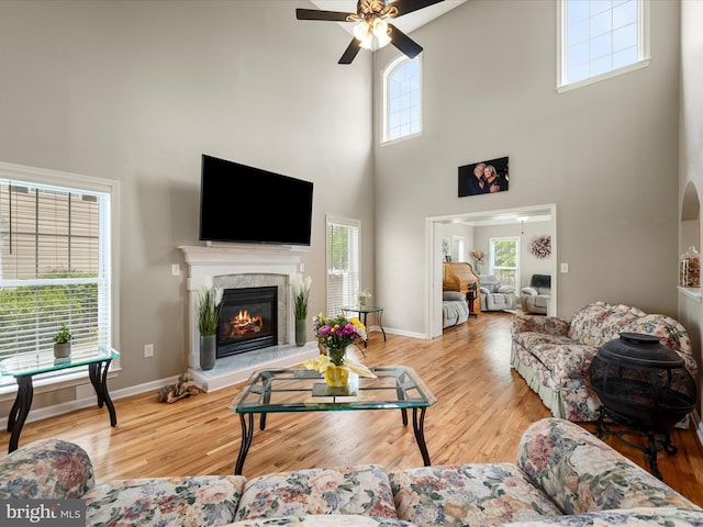 114 New Market Dr, Stephens City, VA 22655 - living area with a towering ceiling, a ceiling fan, wood finished floors, and a high end fireplace