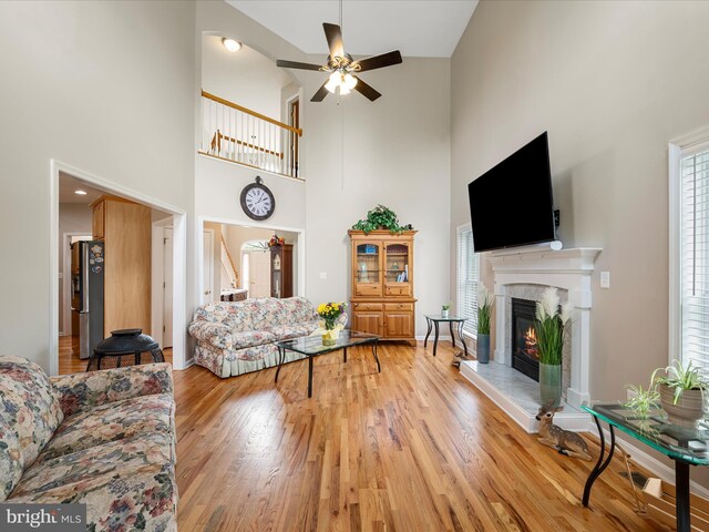 114 New Market Dr, Stephens City, VA 22655 - living area with a high ceiling, ceiling fan, a high end fireplace, and light wood finished floors