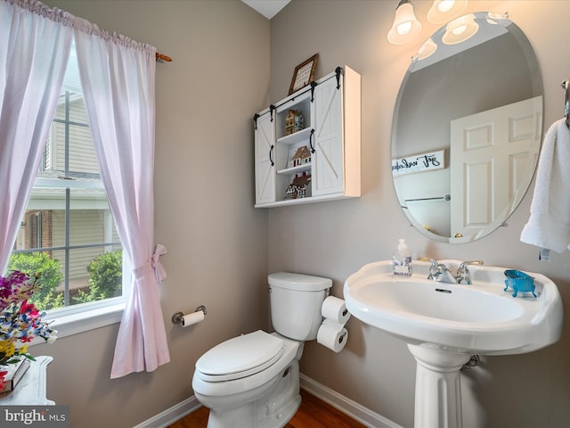 114 New Market Dr, Stephens City, VA 22655 - bathroom with healthy amount of natural light, toilet, baseboards, and wood finished floors