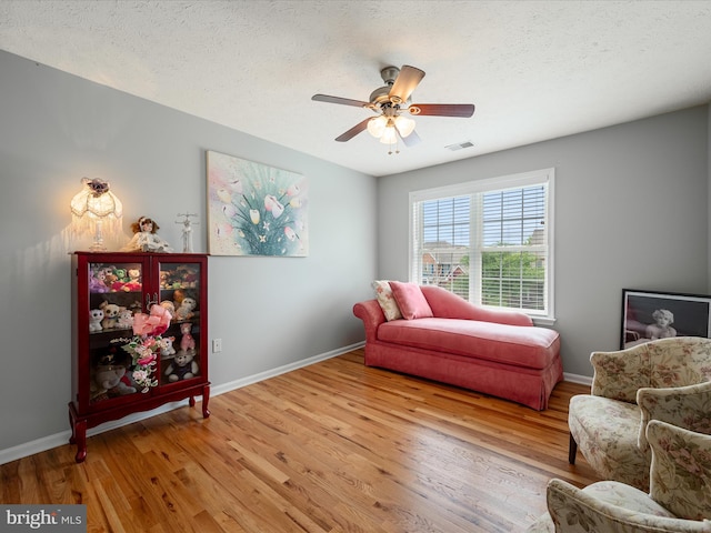 114 New Market Dr, Stephens City, VA 22655 - living area with light wood-type flooring, baseboards, ceiling fan, and a textured ceiling