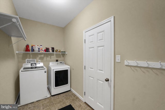 laundry room featuring laundry area, washer and clothes dryer, and baseboards