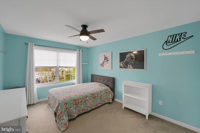 carpeted bedroom featuring baseboards and ceiling fan