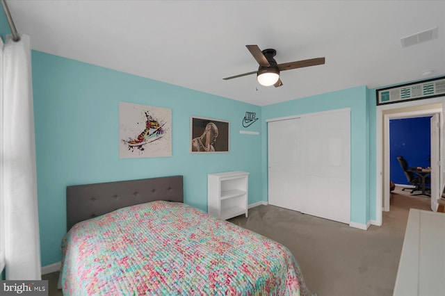 carpeted bedroom with a ceiling fan, a closet, baseboards, and visible vents